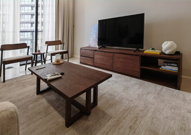 Dark stained melunak TV cabinet and matching coffee table set in modern apartment living room